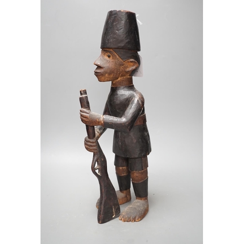 1372 - A late 19th century Belgian Congo carved wood figure of a sepoy  Height 44 cm