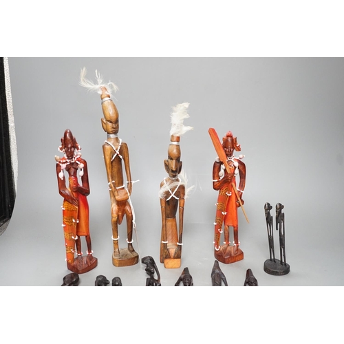 1383 - 12 African carved wood stick figures, tallest 38cms high