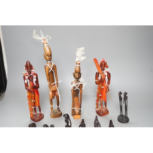 1383 - 12 African carved wood stick figures, tallest 38cms high