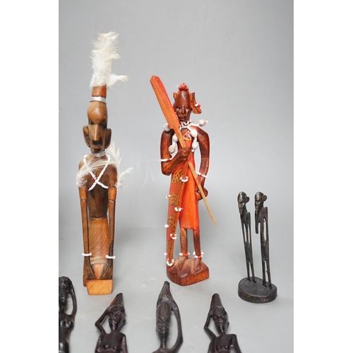 1383 - 12 African carved wood stick figures, tallest 38cms high