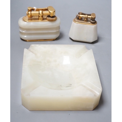 1495 - Two Dunhill green onyx table lighters and a matching ashtray, largest lighter 10cms wide