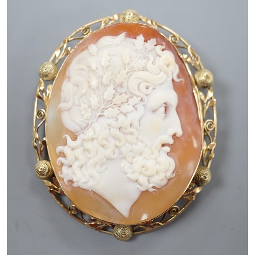 1891 - After the antique- A yellow metal mounted oval cameo shell brooch, carved with the head of a Zeus to... 