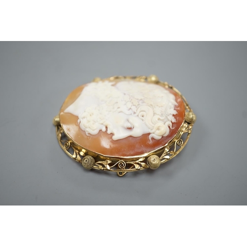 1891 - After the antique- A yellow metal mounted oval cameo shell brooch, carved with the head of a Zeus to... 