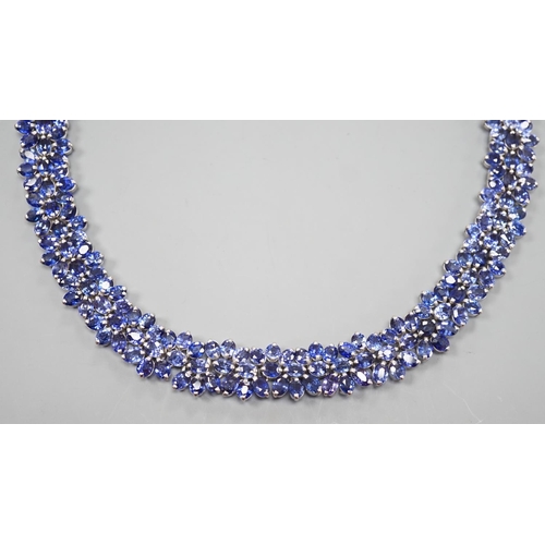 1892 - A continental base metal and synthetic sapphire? flower head cluster set necklace, approximately 39c... 