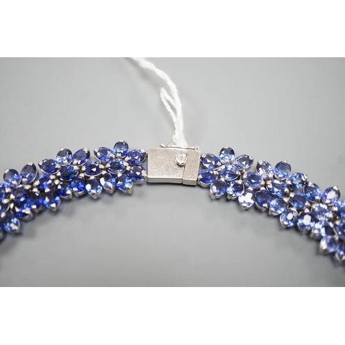 1892 - A continental base metal and synthetic sapphire? flower head cluster set necklace, approximately 39c... 