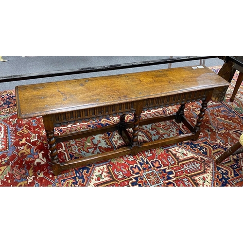 131 - A 18th century style oak bench, with twist uprights, length 121cm, depth 30cm, height 46cm