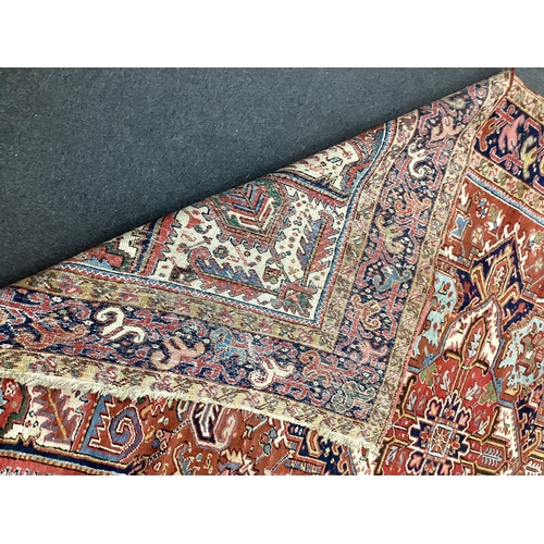 134 - An early 20th century Heriz red ground carpet, 336 x 250cm