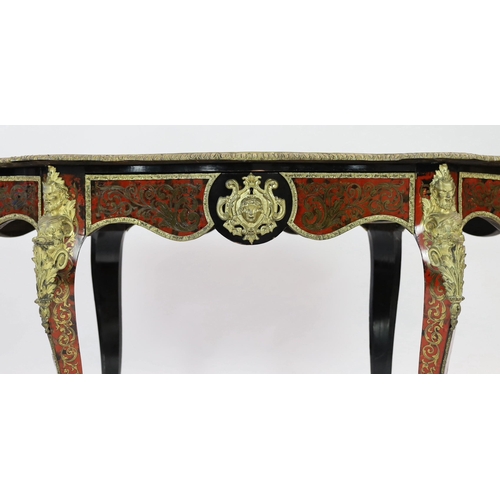 144 - A 19th century French red boulle bureau plat, of serpentine oval form with foliate scrolling inlaid ... 