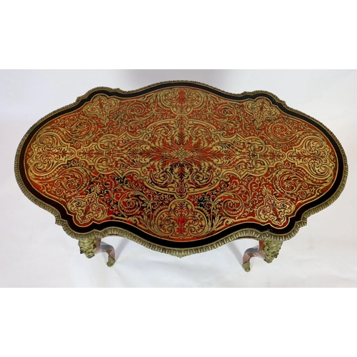 144 - A 19th century French red boulle bureau plat, of serpentine oval form with foliate scrolling inlaid ... 