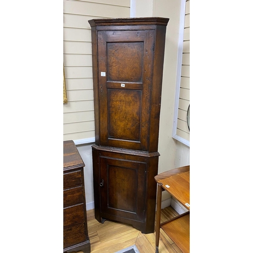 154 - A 18th style oak standing corner cabinet, width 66cm, depth 34cm, height 190cm