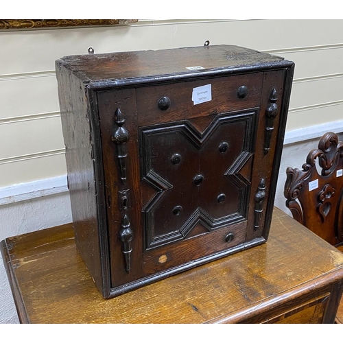 159 - A Jacobean oak spice cupboard, enclosed by a geometric panelled door, width 45cm, depth 23cm, height... 