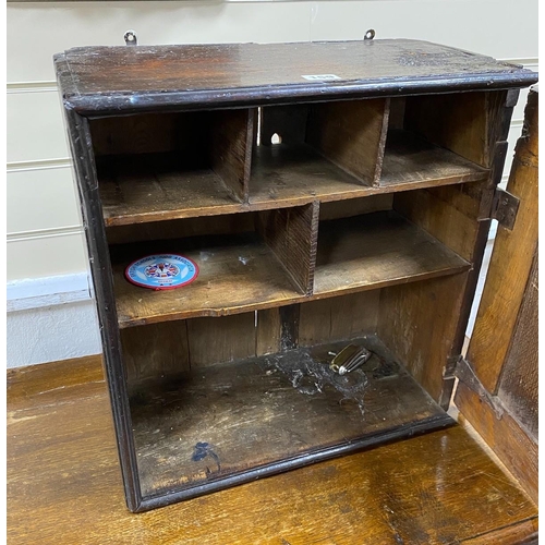 159 - A Jacobean oak spice cupboard, enclosed by a geometric panelled door, width 45cm, depth 23cm, height... 