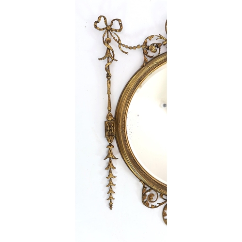 165 - A late Victorian Adam Revival oval wall mirror, with urn, foliate scroll, ribbon and harebell motifs... 