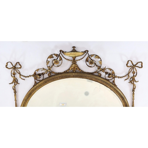 165 - A late Victorian Adam Revival oval wall mirror, with urn, foliate scroll, ribbon and harebell motifs... 