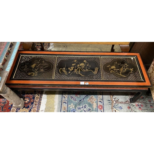 18 - A Chinese black and red lacquered coffee table, the top inset three 18th century lacquer panels, len... 