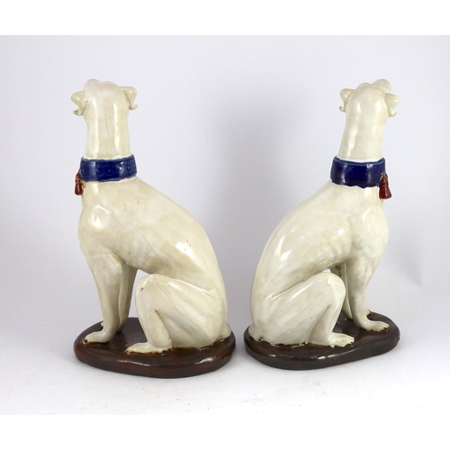 265 - A pair of Italian tin-glaze earthenware figures of seated greyhounds,  35cm high