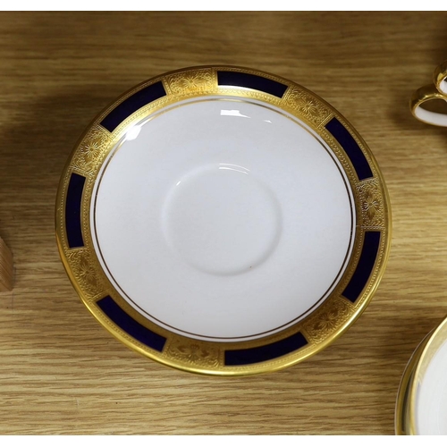 298 - An Aynsley blue and gilt part dinner service