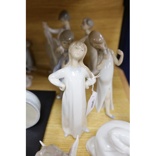 302 - A Lladro collection: seven figures, five further damaged figures and a Lladro reference book