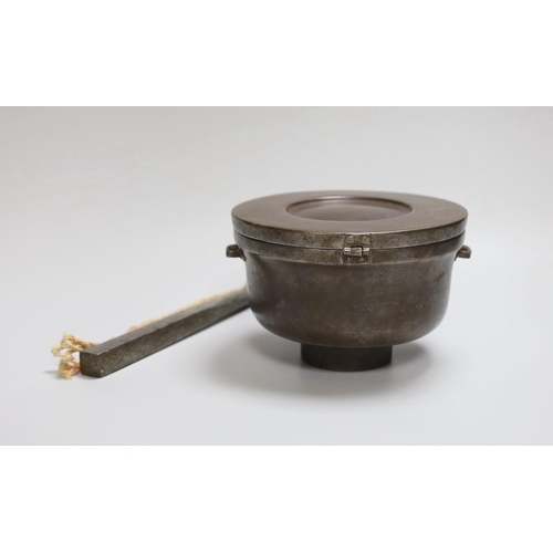 309 - A Tibetan stunning weight and a Tibetan saddle storage pot