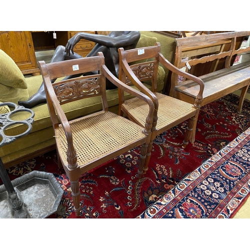 31 - A pair of Indonesian caned hardwood elbow chairs, width 55cm, depth 44cm, height 86cm