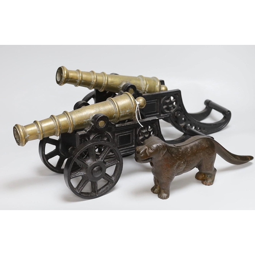 312 - A pair of cast iron and bronze model cannons and a cast iron dog nut cracker, cannons 42.5cm long... 