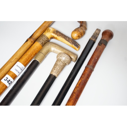 342 - Two Victorian silver mounted walking sticks, a sword stick and three other sticks (6)