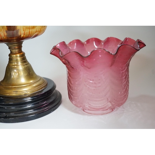 351 - A Victorian brass and cranberry glass oil lamp