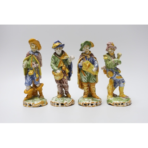 404 - A set of four 19th century faience figures of street peddlers or performers - 18cm tall