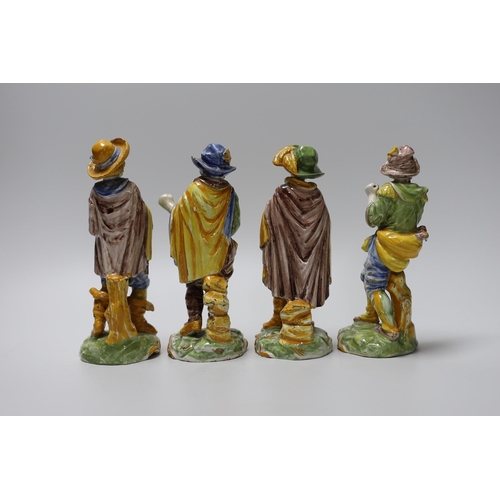 404 - A set of four 19th century faience figures of street peddlers or performers - 18cm tall