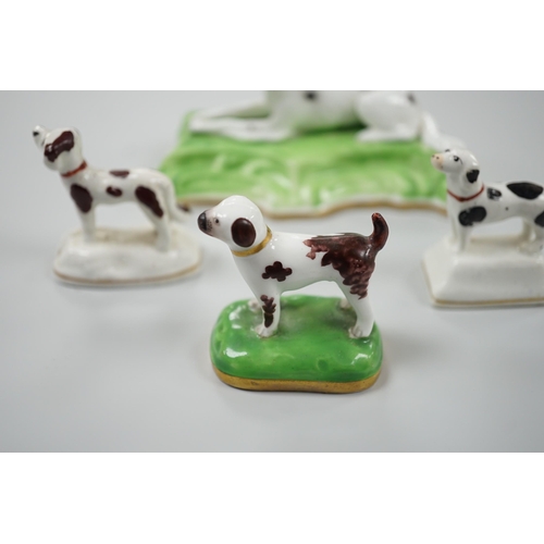 415 - Three toy Staffordshire models of standing terriers; two with brown spots and the other black spots,... 