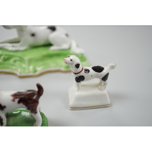 415 - Three toy Staffordshire models of standing terriers; two with brown spots and the other black spots,... 