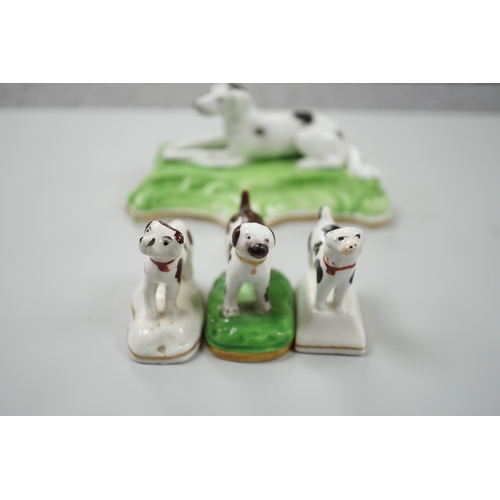 415 - Three toy Staffordshire models of standing terriers; two with brown spots and the other black spots,... 