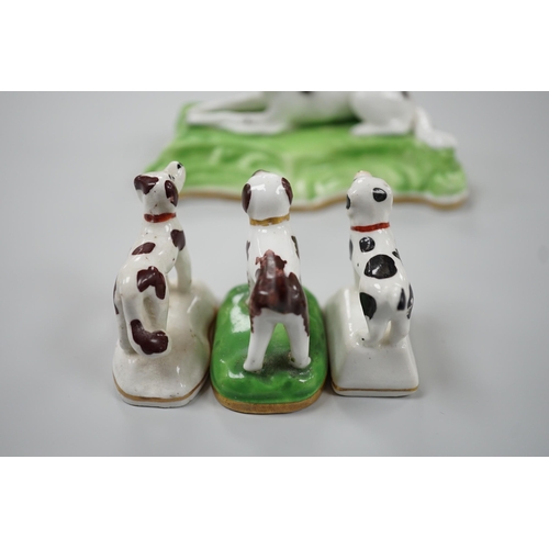 415 - Three toy Staffordshire models of standing terriers; two with brown spots and the other black spots,... 