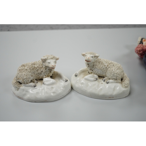 417 - Three small Staffordshire models of recumbent sheep on oval mounted bases, together with a Staffords... 