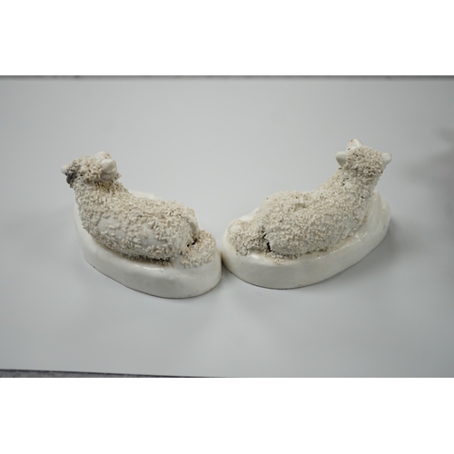 417 - Three small Staffordshire models of recumbent sheep on oval mounted bases, together with a Staffords... 