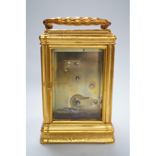 418 - A late 19th century French eight day timepiece, in an engraved brass gorge case. 12cm tall