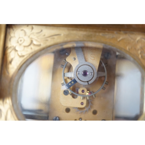 418 - A late 19th century French eight day timepiece, in an engraved brass gorge case. 12cm tall