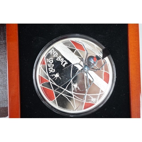 444 - A World Money Fair Red back spider 5oz. Proof silver coin, three art colour 1oz. Silver dollars and ... 