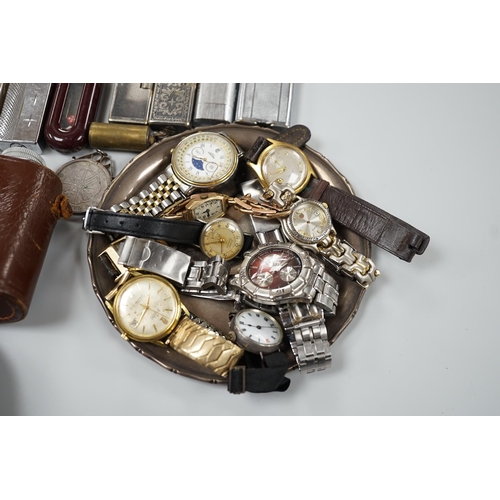 446 - A collection of mixed wristwatches and cigarette lighters and a camera