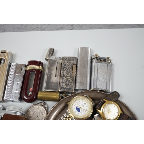 446 - A collection of mixed wristwatches and cigarette lighters and a camera