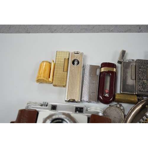 446 - A collection of mixed wristwatches and cigarette lighters and a camera