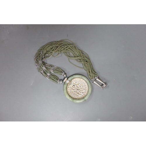 462 - A Kai-Yin-Lo of Hong Kong jadeite and white metal mounted necklace, 81cm.