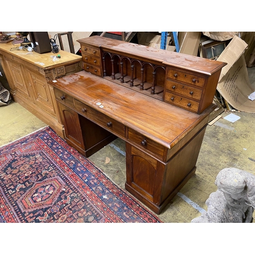 60 - A Victorian style hardwood kneehole desk with galleried superstructure, length 140cm, depth 64cm, he... 