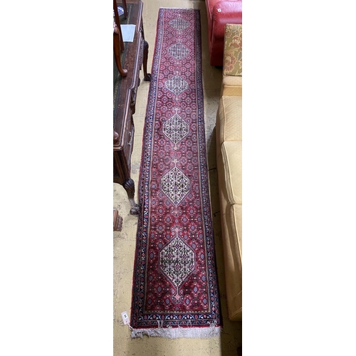 84 - A North West Persian red ground runner, 366 x 55cm