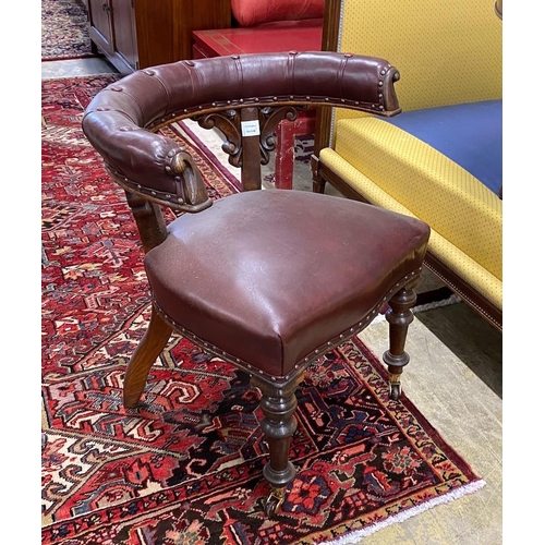 87 - A Victorian oak and burgundy leather desk chair, width 66cm, depth 50cm, height 76cm