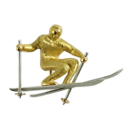 877 - A gold and platinum novelty brooch modelled as a skier, length 39mm, 9.3 grams.