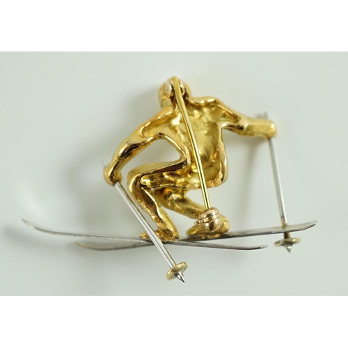 877 - A gold and platinum novelty brooch modelled as a skier, length 39mm, 9.3 grams.