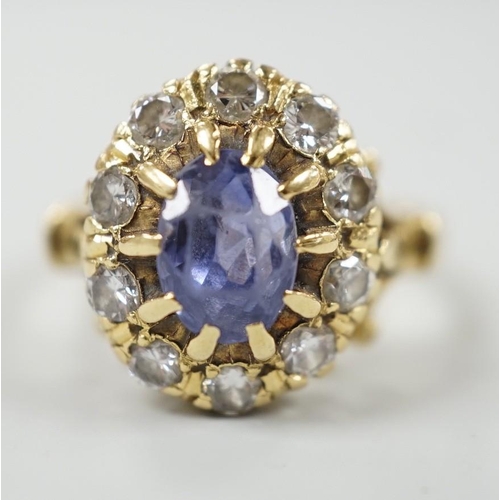 883 - An early to mid 20th century yellow metal, sapphire and diamond set oval cluster dress ring, size... 