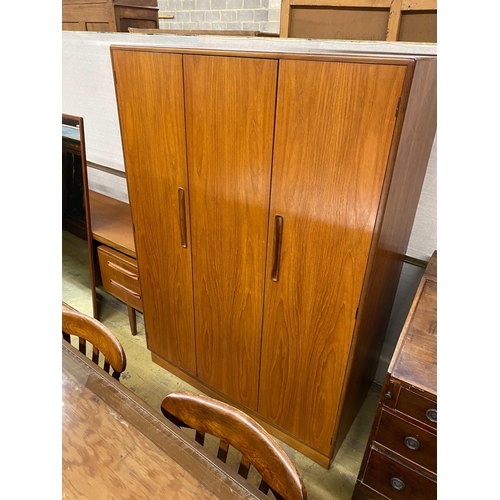 1011 - A G-plan teak three piece bedroom suite, comprising wardrobe, width 121cm, depth 58cm, height 176cm,... 