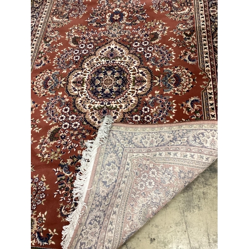 1023 - A modern Tabriz style red ground rug, 240 x 162cm